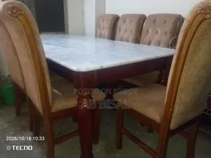 A marble dining table with 6 chairs for sale
