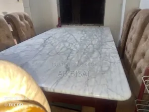 A marble dining table with 6 chairs for sale