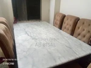 A marble dining table with 6 chairs for sale