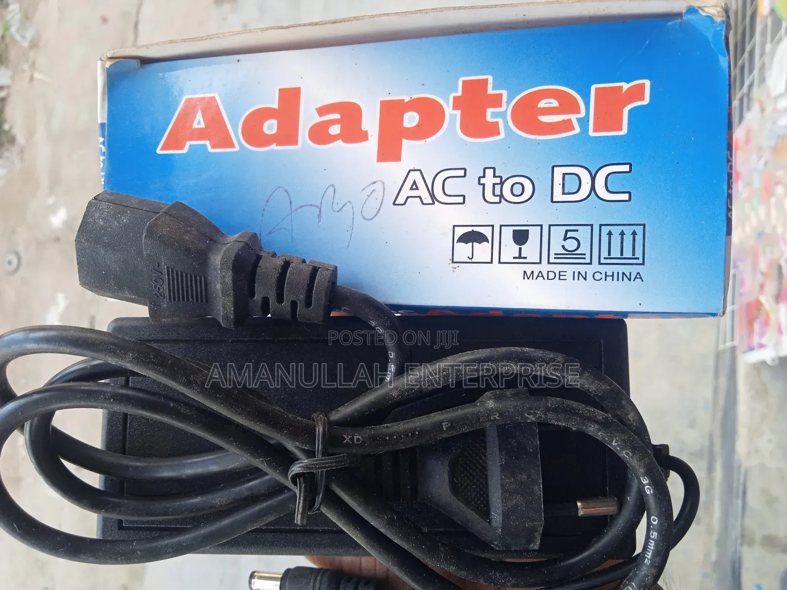 Ac - Dc Power Adapter Powering Various Electronic Devices.