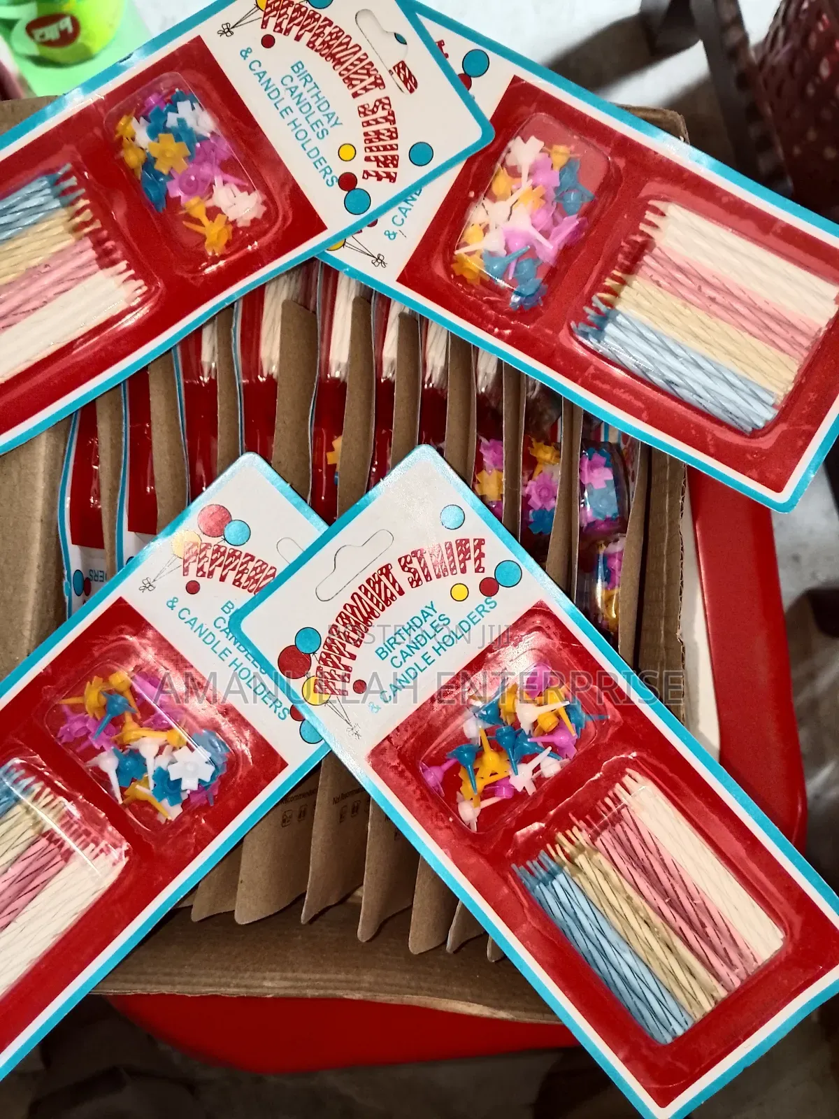 Multicolored Spiral Birthday Candles and Small, Flower-Shaped Candle.