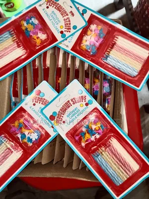 Multicolored Spiral Birthday Candles and Small, Flower-Shaped Candle.