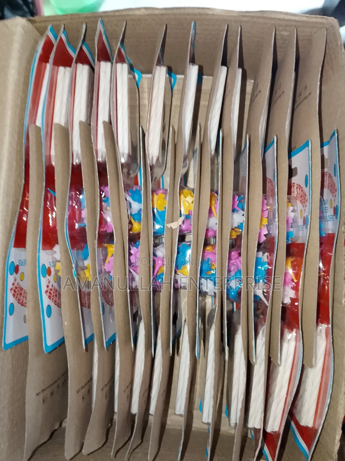 Multicolored Spiral Birthday Candles and Small, Flower-Shaped Candle.