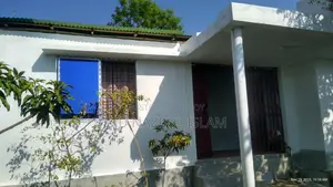 Land with house for sale.