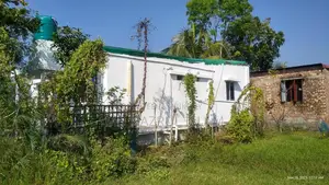 Land with house for sale.