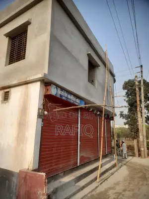 Urgent sale of a new two-story building with shop and garage.