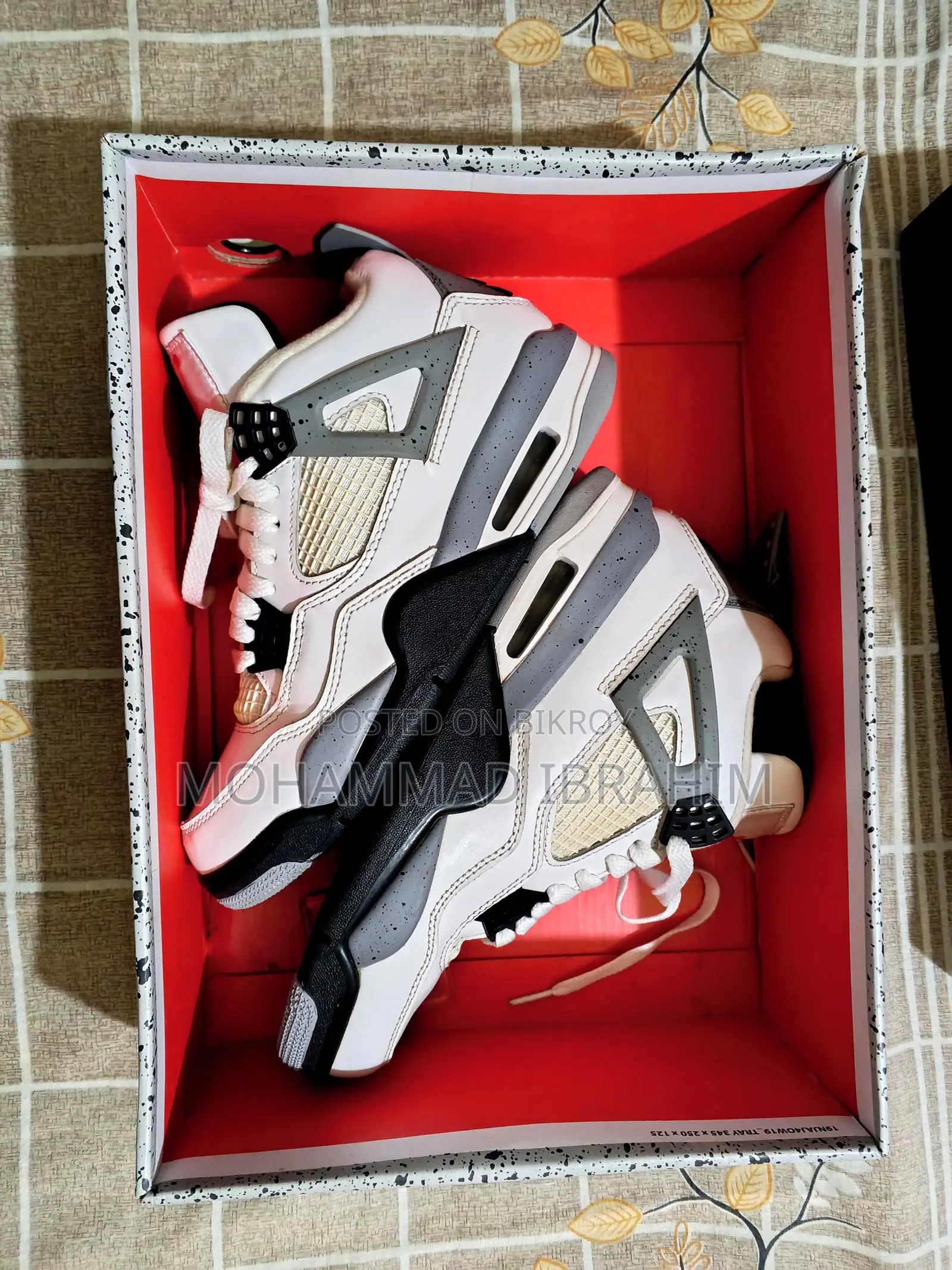 A pair of used branded sports sneakers for sale.