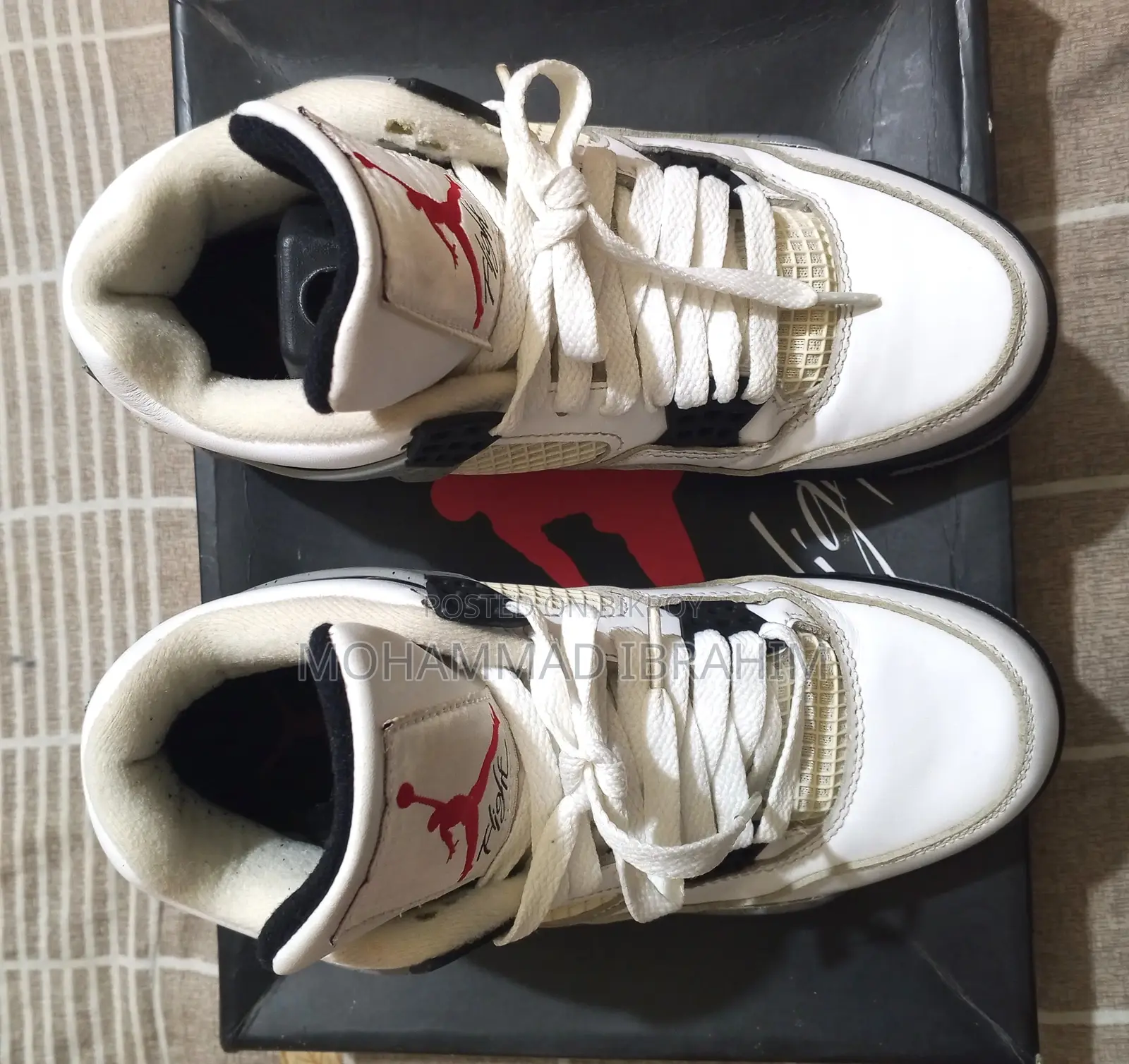 A pair of used branded sports sneakers for sale.
