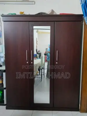 Three-door Canadian board wardrobe for sale.