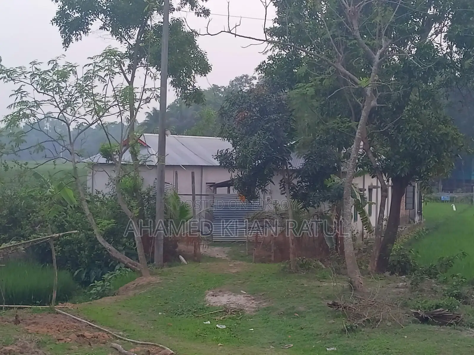 Land with house for sale.