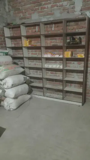 Shop front cash table, three racks, and a large wooden chair