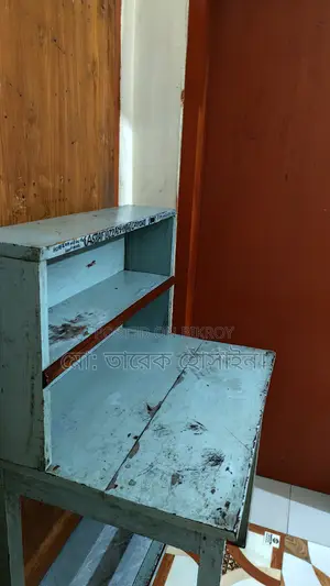 A wooden table and an RFL plastic chair