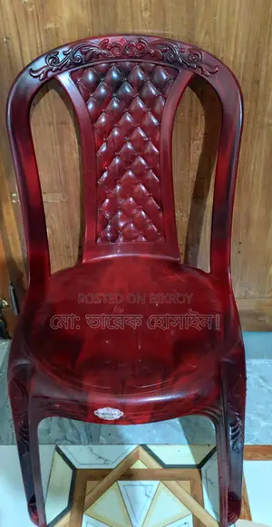 A wooden table and an RFL plastic chair