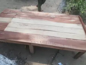 Two wooden beds and a gorgeous table.