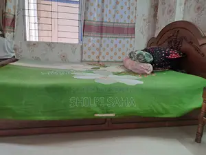সেগুন কাঠের বক্স খাট জাজিম সহকারে।