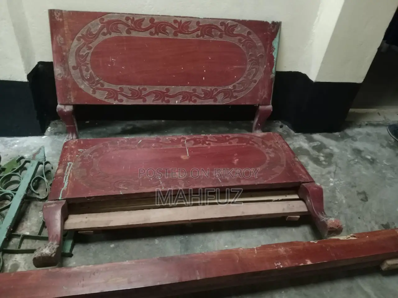 Two beds for sale: one wooden and one steel.
