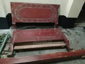 Two beds for sale: one wooden and one steel.