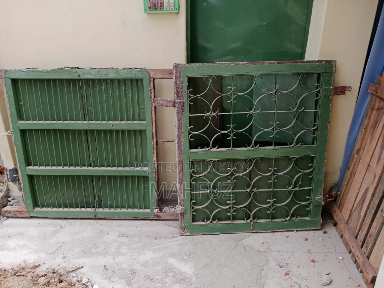 Two beds for sale: one wooden and one steel.