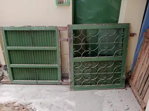 Two beds for sale: one wooden and one steel.