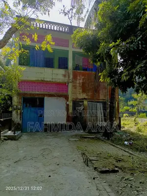 Two-story house with land for sale.