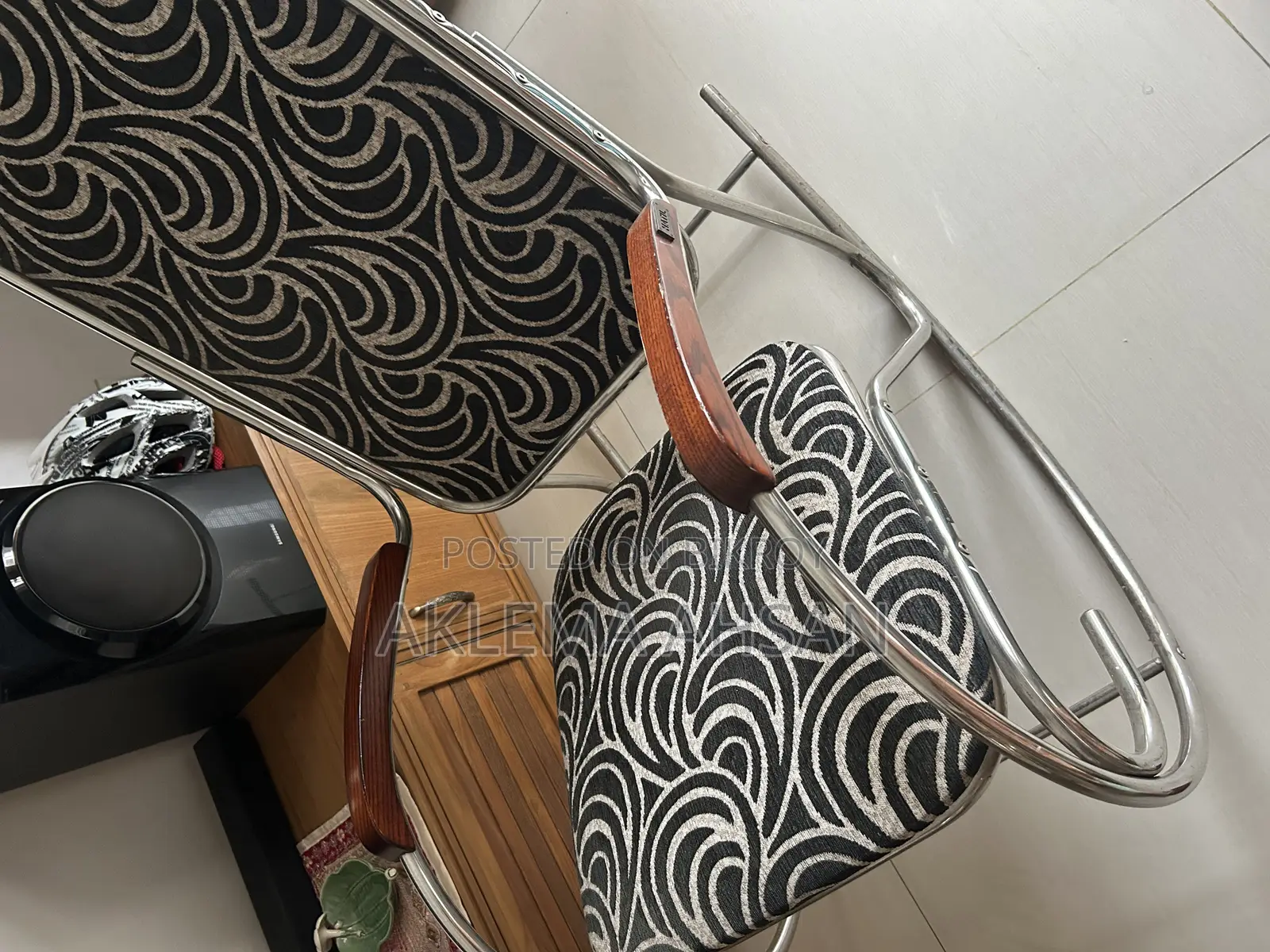 Revolving Chair, black fabric, steel armrests, and steel base