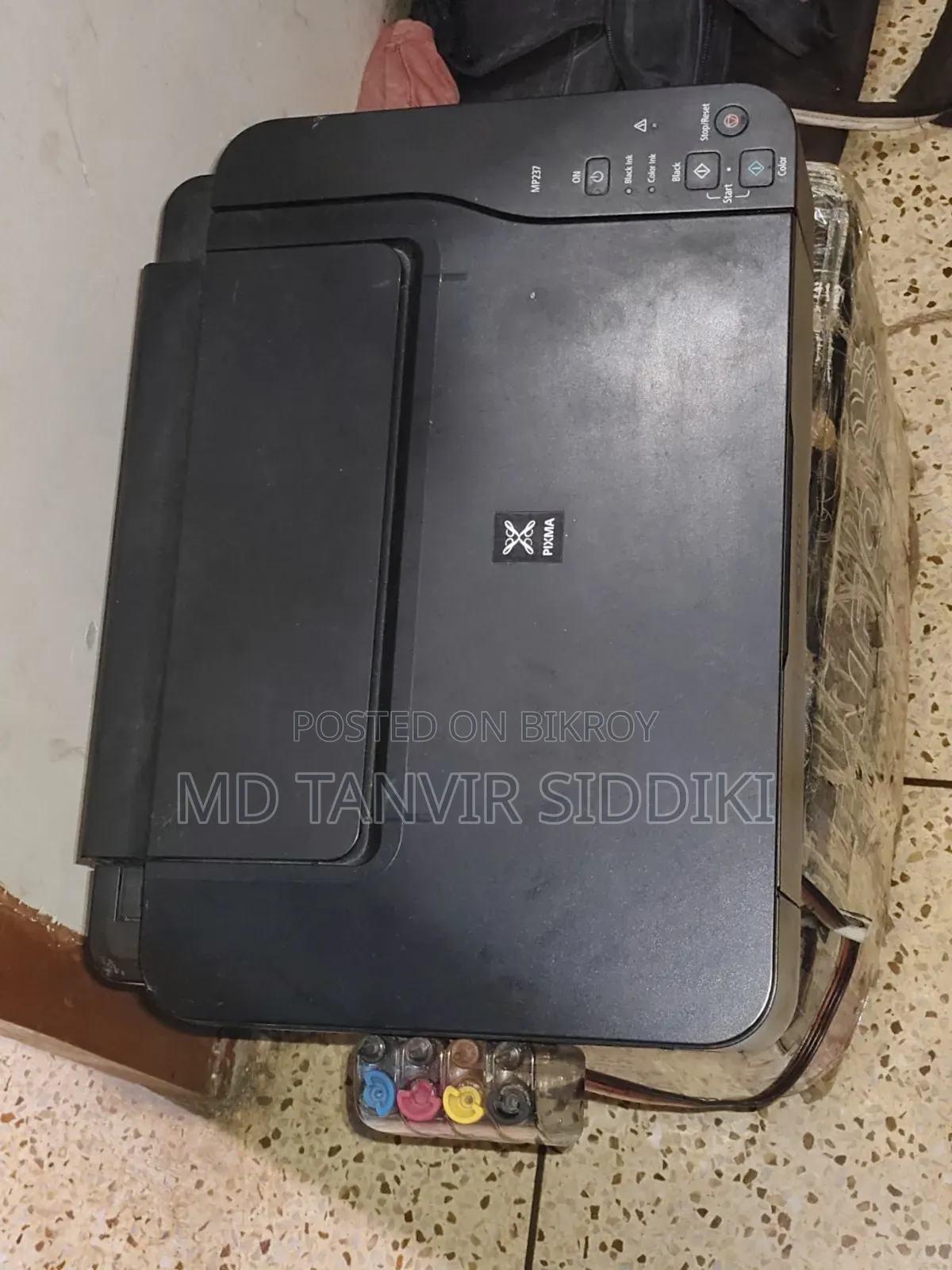 This printer turns on but the output cable is missing.