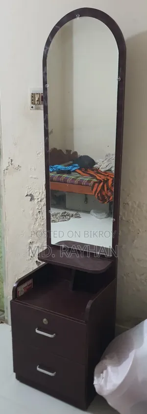 A small dressing table. Has two drawers, one with a lock system.