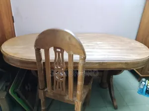 Large wooden dining table and 5 wooden chairs