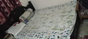 Old but large size wooden bed for sale.