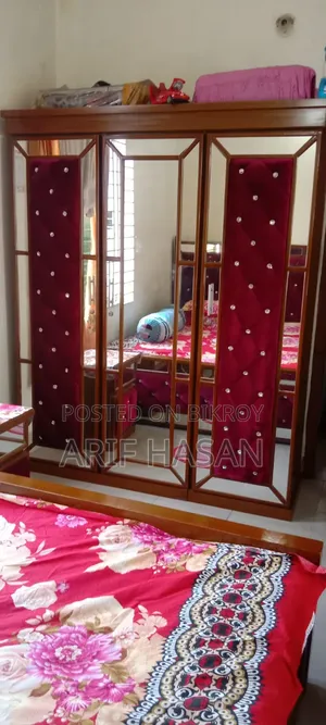 Home furniture set including a bed, cupboard, wardrobe, and dressing table