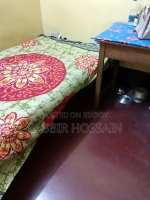 Single wooden cot and wooden table
