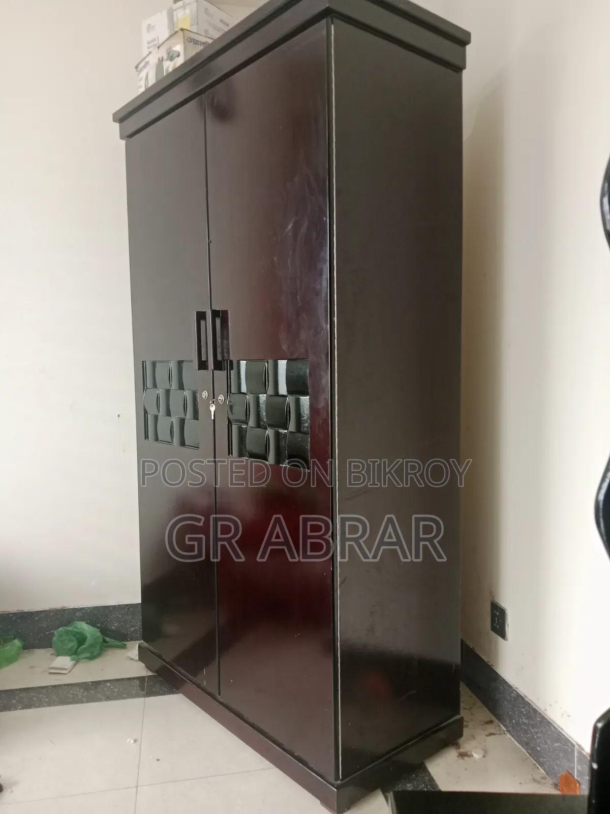 A new Malaysian wood wardrobe for sale.