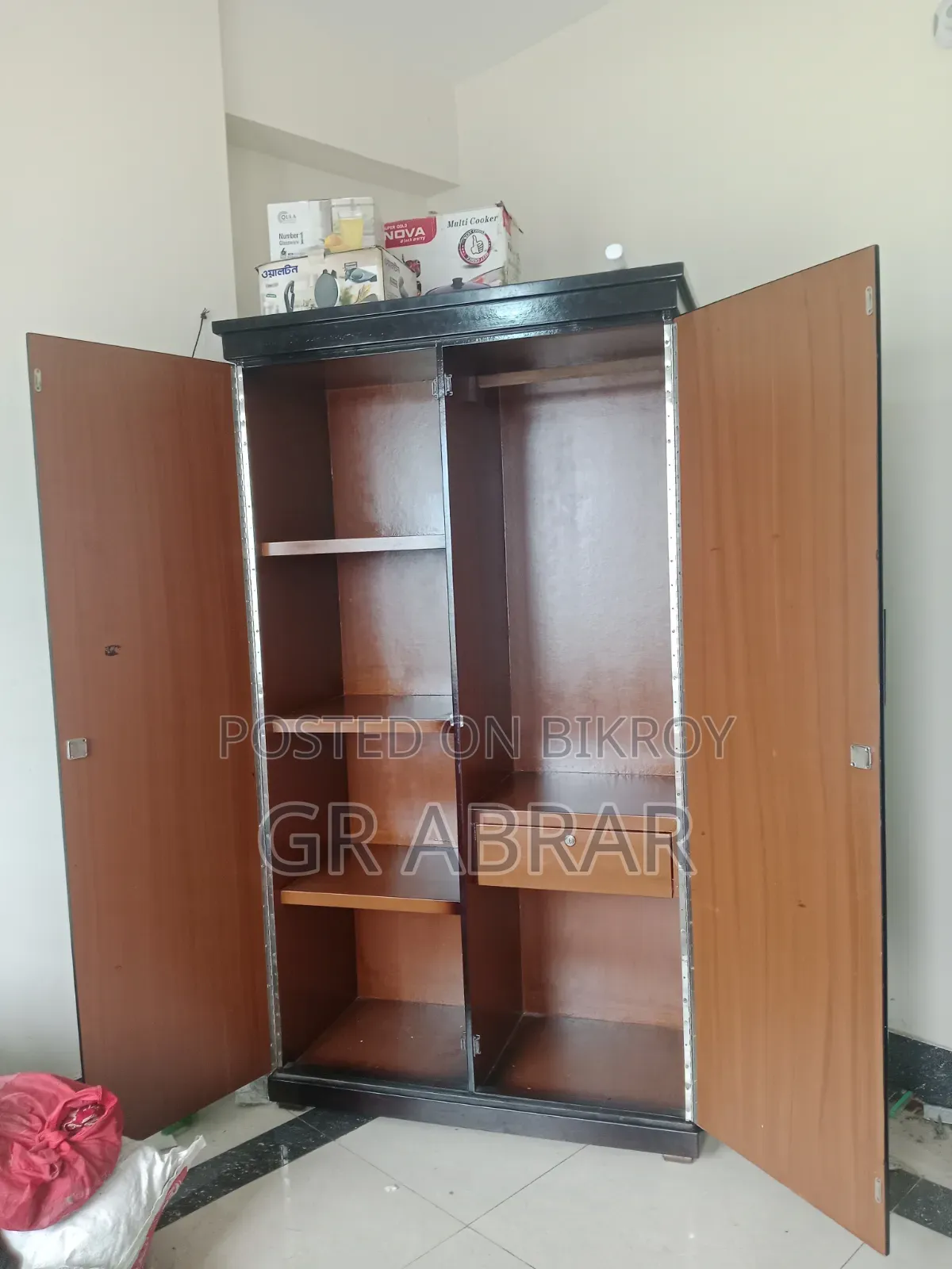 A new Malaysian wood wardrobe for sale.