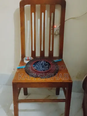A teak wood chair is for sale at a low price.