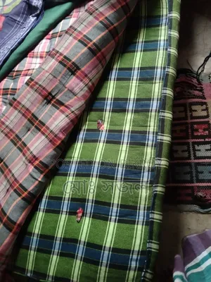 A mattress and a quilt for sale.