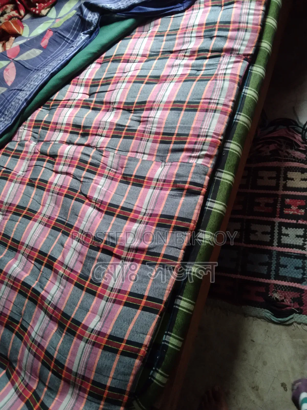 A mattress and a quilt for sale.