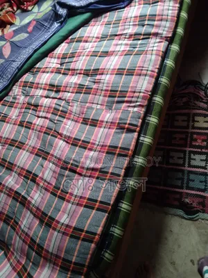 A mattress and a quilt for sale.