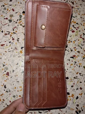 এটি বাদামী চামড়ার ওয়ালেট, যার কিনারায় সেলাইয়ের কাজ করা আছে।
