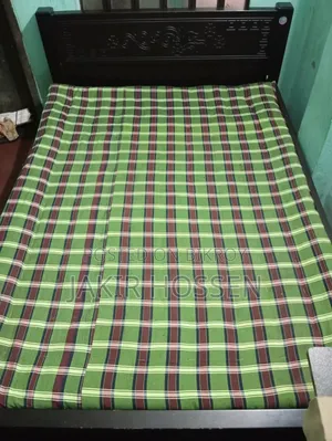 A 5/7 feet size bed for sale including mattress. Made of Malaysian wood.