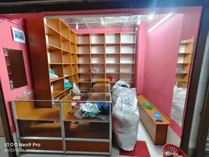 Garment shop shelves (with glass), cash counter and stool