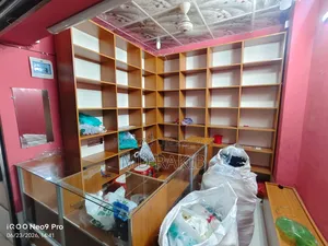 Garment shop shelves (with glass), cash counter and stool