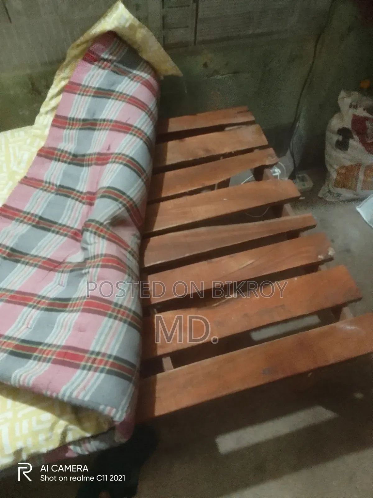 A single bed frame and mattress