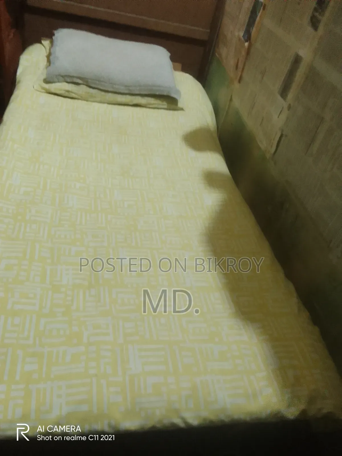 A single bed frame and mattress