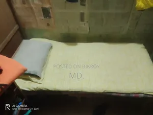 A single bed frame and mattress