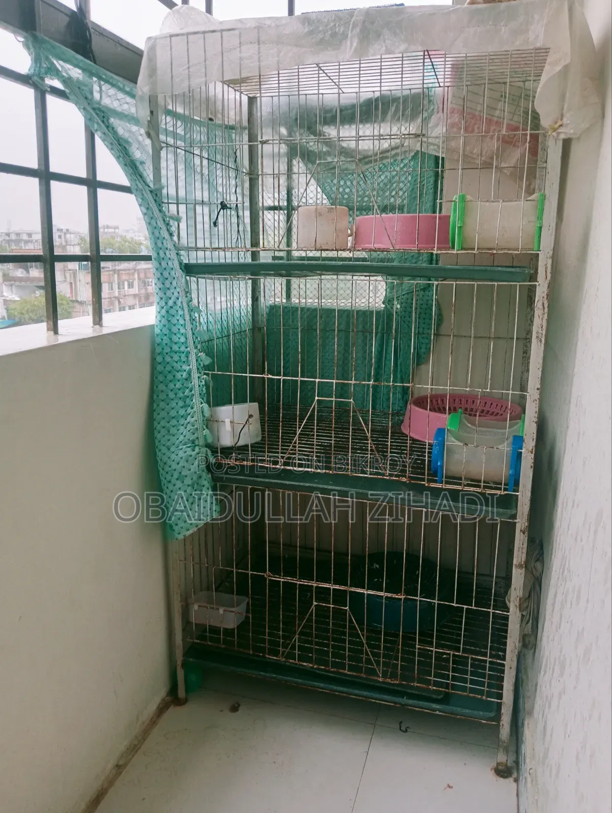 An iron bird cage for sale.