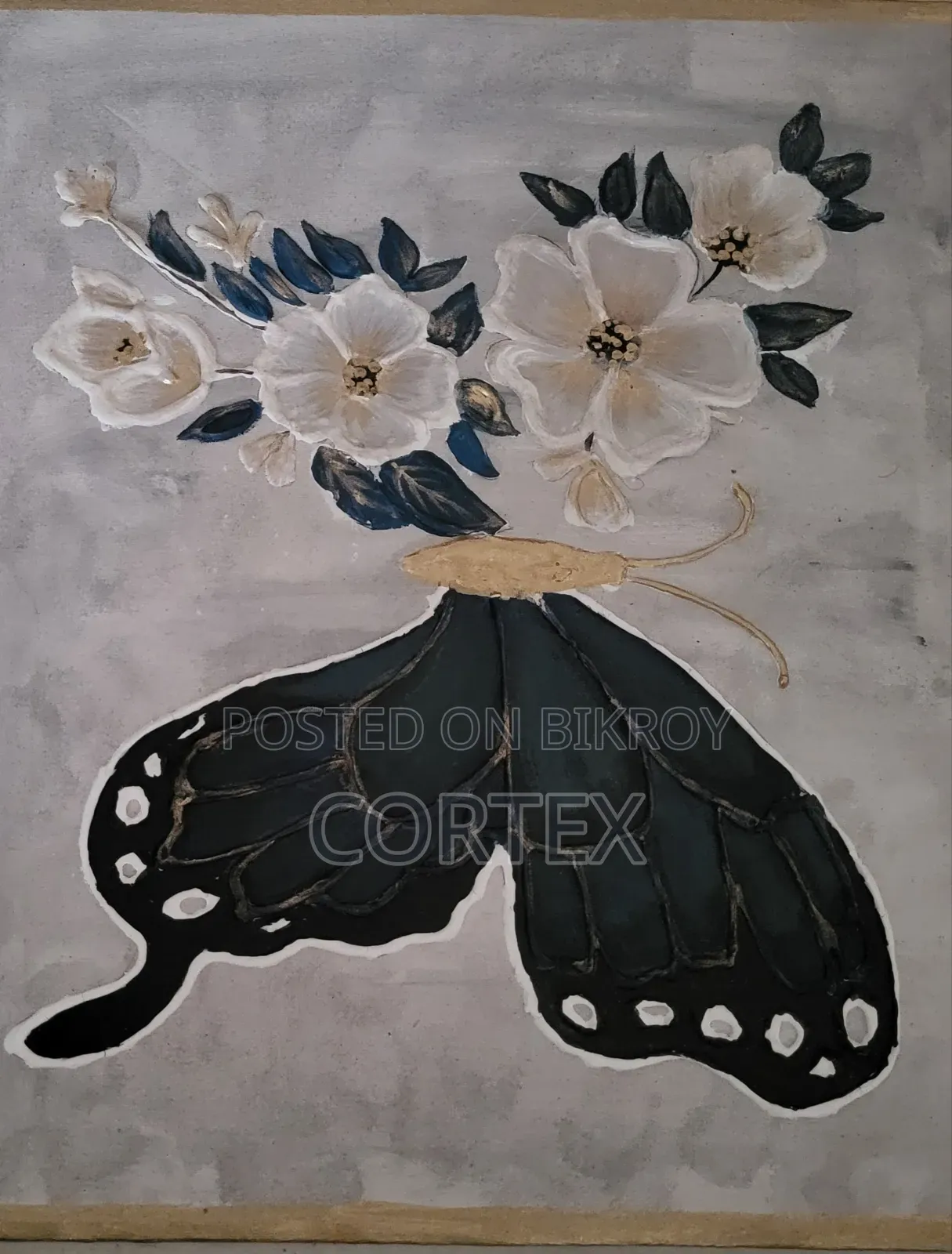 This is a handmade mixed-media artwork of a butterfly and flowers.
