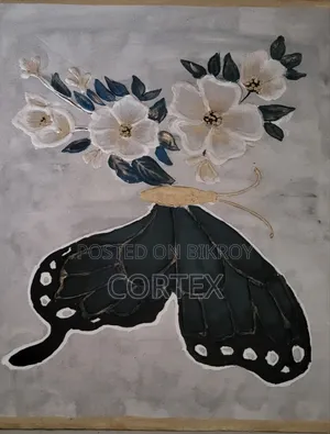 This is a handmade mixed-media artwork of a butterfly and flowers.