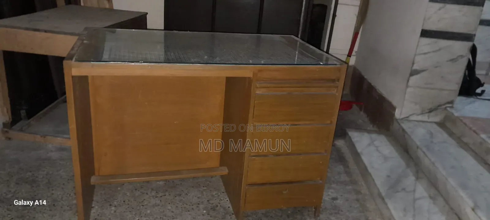 A wooden bed and a computer table