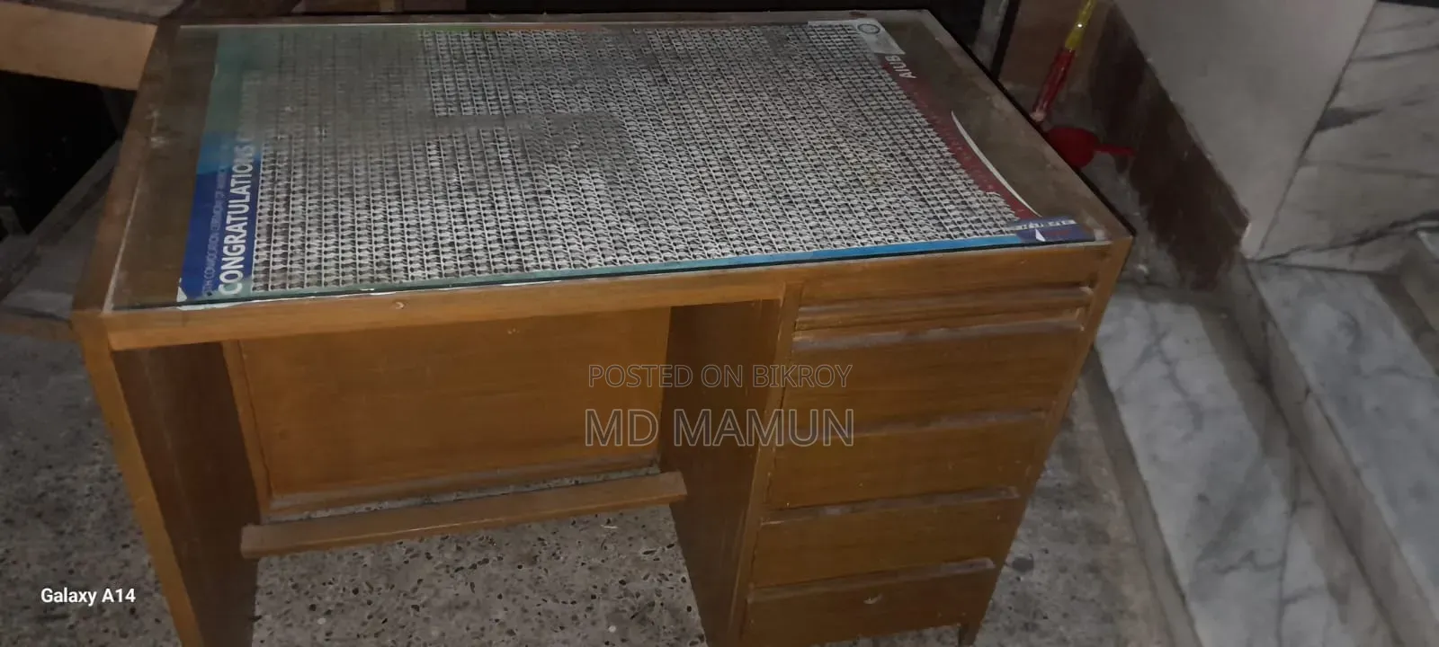 A wooden bed and a computer table