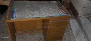 A wooden bed and a computer table